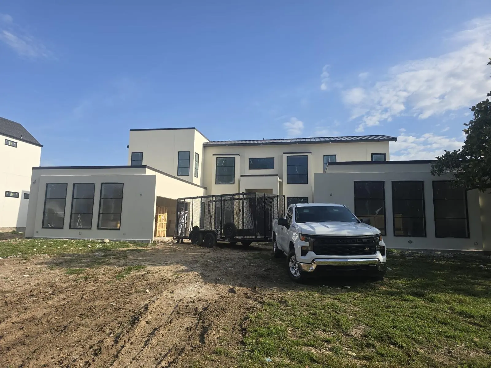 Oklahoma home construction project with newly installed windows and painted exterior nearing completion